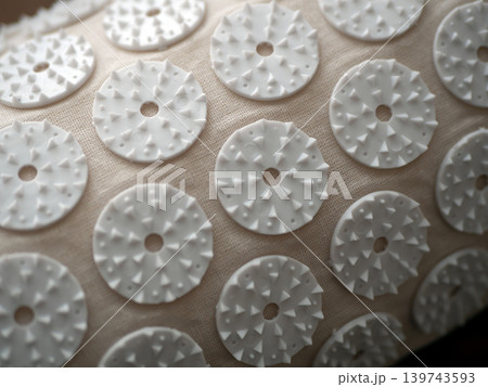 White massage applicator pads on a textured fabric surface. Home wellness tool for relaxation, acupressure, and body care White massage applicator pads on a textured fabric surface. Home wellness tool for relaxation, acupressure, and body care 139743593