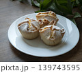 Sofionni pastries on a white plate. Traditional Italian-style dessert with powdered sugar 139743595