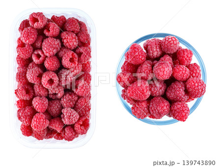 Fresh raspberries in plastic container and glass bowl isolated on white background Fresh raspberries in plastic container and glass bowl isolated on white background 139743890