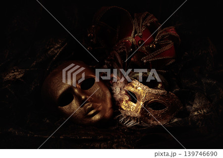 Golden carnival masks on a dark background. 139746690
