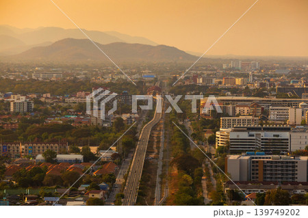 Aerial view of a sprawling city with mountains in the background during golden hour Aerial view of a sprawling city with mountains in the background during golden hour 139749202