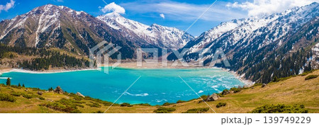 Spectacular wide panoramic view of turquoise Big Almaty Lake surrounded by snow capped Tian Shan mountains Kazakhstan 139749229