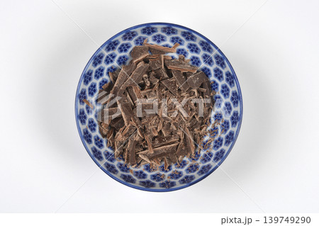 Chopped dark chocolate in a blue patterned bowl Chopped dark chocolate in a blue patterned bowl 139749290
