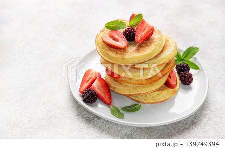 Stack of pancakes with fresh berries and mint 139749394