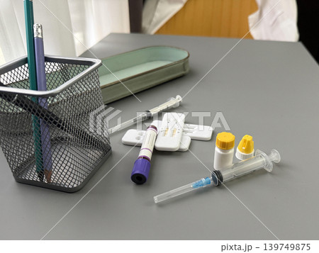 a desk with a syringe and a medical tests 139749875