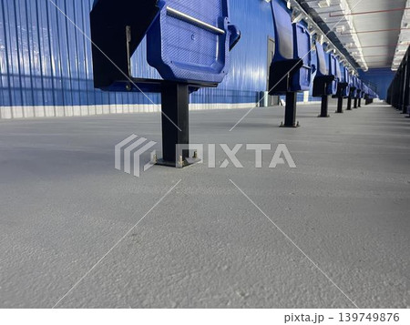 benches, stairs and an empty stadium for a sporting event benches, stairs and an empty stadium for a sporting event 139749876