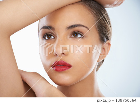 Cosmetic, makeup and young woman in studio with natural, beauty and face routine with red lipstick. Self care, confident and female model with facial cosmetology treatment by gray background. Cosmetic, makeup and young woman in studio with natural, beauty and face routine with red lipstick. Self care, confident and female model with facial cosmetology treatment by gray background. 139750364