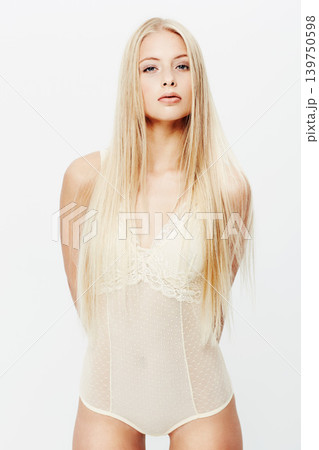 Portrait, model or beauty in lingerie in studio, confident or underwear for glow of body care. Young woman, face and cosmetics in trendy clothes with pride, blonde hair and makeup by white background Portrait, model or beauty in lingerie in studio, confident or underwear for glow of body care. Young woman, face and cosmetics in trendy clothes with pride, blonde hair and makeup by white background 139750598