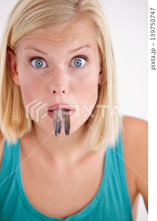 Surprise, woman and portrait eating fish with shock on white background of studio. Wow, crazy and person on diet with fear of weird seafood, cuisine and disgust in mouth for gross, tail and food Surprise, woman and portrait eating fish with shock on white background of studio. Wow, crazy and person on diet with fear of weird seafood, cuisine and disgust in mouth for gross, tail and food 139750747
