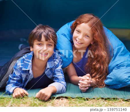 Happy, camping and portrait of children in sleeping bag for resting, relax and comfortable in tent. Travel gear, smile and kids in sleep sack for adventure on holiday, vacation and weekend outdoors Happy, camping and portrait of children in sleeping bag for resting, relax and comfortable in tent. Travel gear, smile and kids in sleep sack for adventure on holiday, vacation and weekend outdoors 139751140