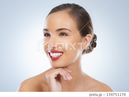 Smile, makeup and young woman in studio with natural, cosmetic and face routine with red lipstick. Self care, confident and female model with facial cosmetology treatment by gray background. Smile, makeup and young woman in studio with natural, cosmetic and face routine with red lipstick. Self care, confident and female model with facial cosmetology treatment by gray background. 139751170