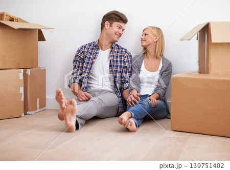Couple, moving and new home with boxes for packing, real estate and happy holding hands for support. Property, achievement or investment with people and cardboard for relocation, mortgage or rent 139751402