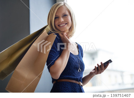 Phone, smile and portrait of woman with shopping bags in retail fashion store or boutique. Happy, technology and female person networking on social media with cellphone for communication in mall. 139751407