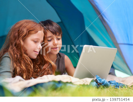 Children, family and happy with laptop in tent for camping, social media and online movie with watching in nature. Friends, face and kids with smile outdoor on grass for gaming, relax and holiday fun 139751454