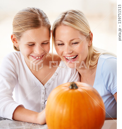 Child, mother and smile with pumpkin to celebrate halloween party together at home. Happy young girl, mom and family carving orange vegetable for holiday lantern, decoration and fun creative craft Child, mother and smile with pumpkin to celebrate halloween party together at home. Happy young girl, mom and family carving orange vegetable for holiday lantern, decoration and fun creative craft 139751515