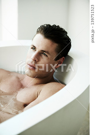 Wellness, idea and man in home bath for hygiene, body care or washing wet skin with water. Thinking, vision and cleaning with young person in bathroom of apartment for health or stress relief 139751523