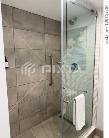 Open shower area with tiled walls and glass door Open shower area with tiled walls and glass door 139751567