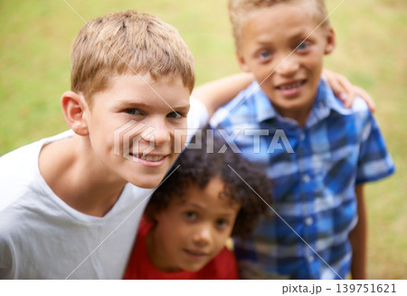 Boy, friends and portrait or happy outdoor in summer with confidence, pride or diversity in nature. Children, face or smile on grass field with embrace for friendship, care and support on playground 139751621