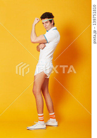 Portrait, tennis and man flexing arms with fitness and workout on a yellow background. Person, model and athlete in sportswear and training with confidence and proud with wellness and healthy Portrait, tennis and man flexing arms with fitness and workout on a yellow background. Person, model and athlete in sportswear and training with confidence and proud with wellness and healthy 139751810