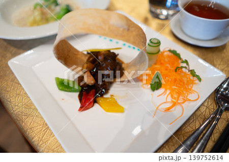 Gourmet Asian Dish with Crispy Decorative Garnish in Luxury Restaurant Gourmet Asian Dish with Crispy Decorative Garnish in Luxury Restaurant 139752614