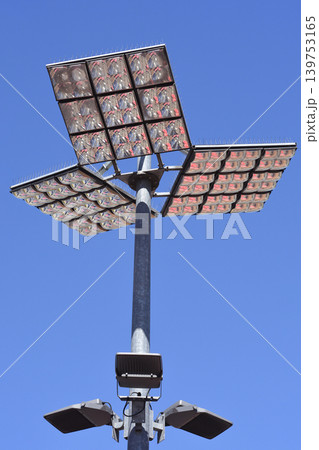 Powerful LED stadium light tower against blue sky 139753165
