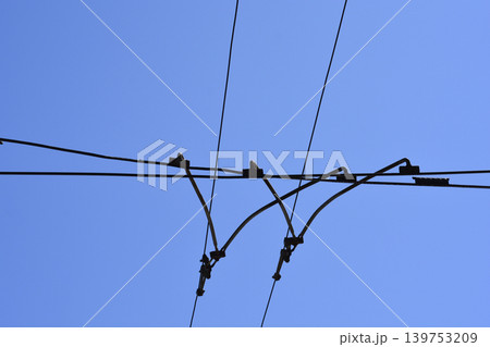 Tram Overhead Power Lines Against Clear Blue Sky Tram Overhead Power Lines Against Clear Blue Sky 139753209