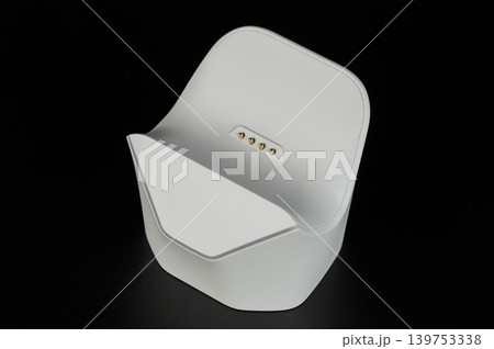 Stand holds device for charging with simple design and white color Stand holds device for charging with simple design and white color 139753338