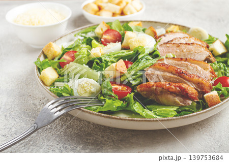 Caesar salad, with duck breast, on a light plate, on a light background, homemade, no people, 139753684