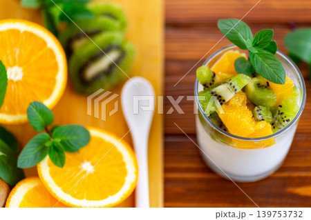 healthy breakfast yogurt with fresh kiwi and orange topping 139753732