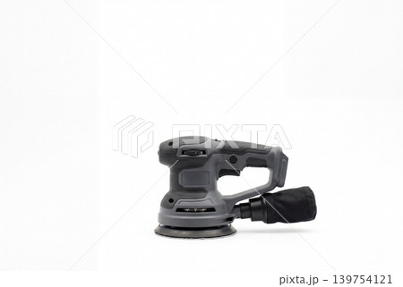 Cordless orbital sander with attached dust bag isolated on white background. Portable power tool for woodworking, surface finishing, renovation, repair and DIY sanding tasks. Cordless orbital sander with attached dust bag isolated on white background. Portable power tool for woodworking, surface finishing, renovation, repair and DIY sanding tasks. 139754121