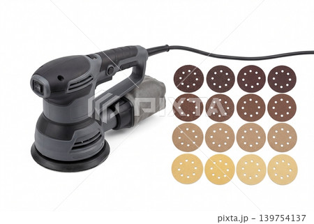 Random orbital sander with dust bag and assorted sanding discs isolated on white background. Electric power tool set for woodworking, surface finishing, renovation, repair and workshop use. Random orbital sander with dust bag and assorted sanding discs isolated on white background. Electric power tool set for woodworking, surface finishing, renovation, repair and workshop use. 139754137