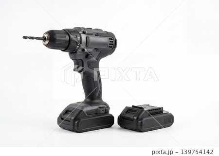 Modern cordless drill with drill bit and extra battery pack isolated on white background. Professional power tool for drilling, repair, construction, installation, woodworking and DIY use. 139754142
