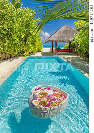 Famous luxury tourism couple honeymoon scenic morning sunlight floating breakfast tray tropical resort swimming pool breathtaking stunning dreamy serene paradise exotic romantic vacation destination Famous luxury tourism couple honeymoon scenic morning sunlight floating breakfast tray tropical resort swimming pool breathtaking stunning dreamy serene paradise exotic romantic vacation destination 139754168