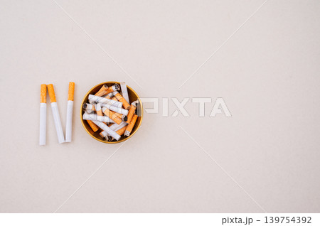 Stop smoking concept with broken cigarette and prohibition sign on cigarette butts Stop smoking concept with broken cigarette and prohibition sign on cigarette butts 139754392