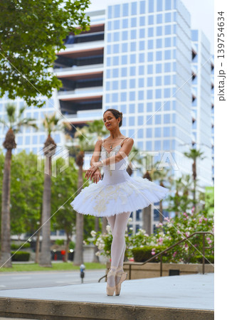 Ballerina standing on pointe in modern city plaza Ballerina standing on pointe in modern city plaza 139754634