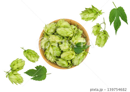 Hop cones in wooden bowl isolated on white background. Beer brewing ingredients. Top view. Flat lay 139754682
