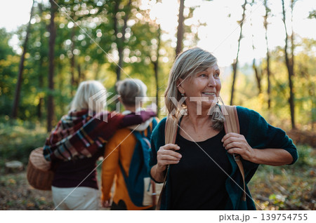 Group of elderly female friends enjoying woodland foraging adventure. Group of elderly female friends enjoying woodland foraging adventure. 139754755