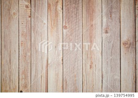 vertical texture of an old fence made of unpainted wooden planks with knots and cracks 139754995