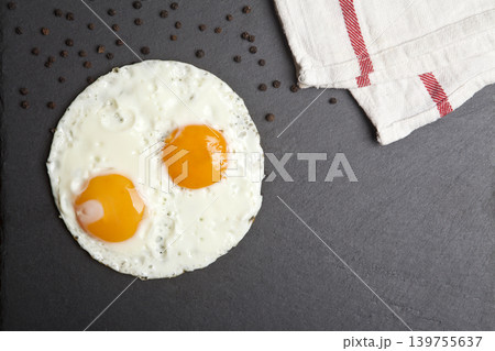 Serving fried eggs on a granite surface. 139755637