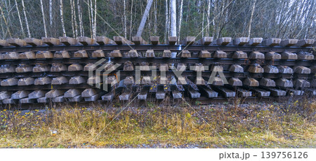 Concrete sleepers recycling. Autumn hues around abandoned industrial infrastructure with plant life 139756126
