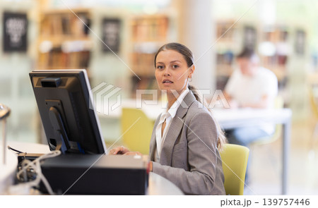 Female student works at computer in library 139757446