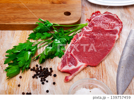 Piece of beef with peas of bitter pepper and parsley Piece of beef with peas of bitter pepper and parsley 139757459