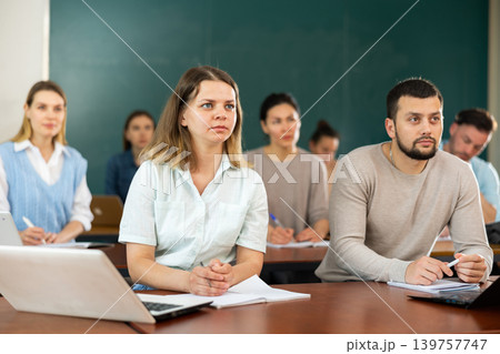 Concentrated students studying in the university auditorium Concentrated students studying in the university auditorium 139757747