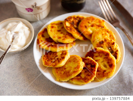 Just cooked syrniki on white plate 139757884