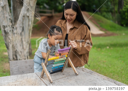 preschool child girl learning and playing colorful wooden abacus with mother preschool child girl learning and playing colorful wooden abacus with mother 139758197