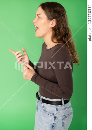 Outraged European young woman is yelling at someone Outraged European young woman is yelling at someone 139758554