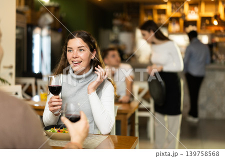 Woman talking to her husband in a restaurant Woman talking to her husband in a restaurant 139758568