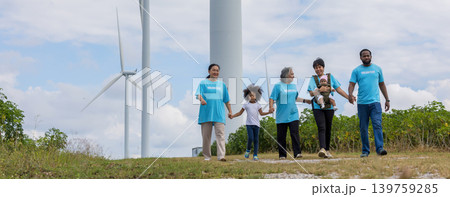 Family with daughter walking on field on wind farm.  139759285