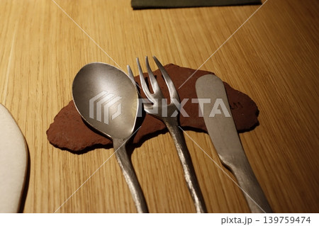 Metal Utensils on Wooden Surface with Stone Accent Metal Utensils on Wooden Surface with Stone Accent 139759474