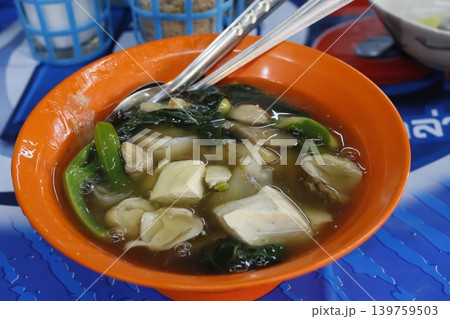Steaming Tofu and Vegetable Soup in Orange Bowl 139759503